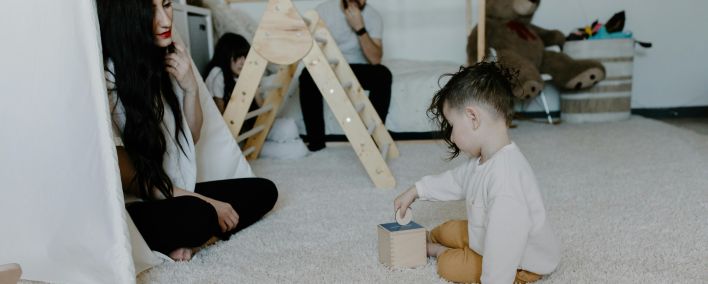 A Girl Playing with a Money Box Toy